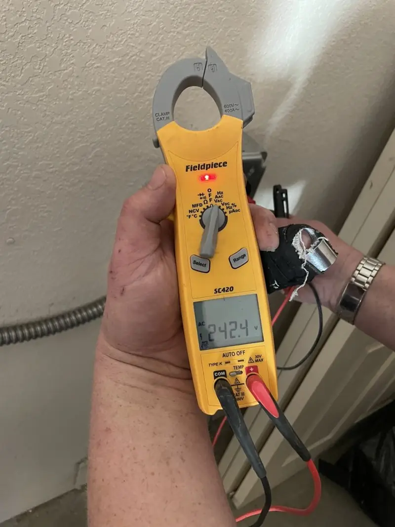 Voltage testing with clamp meter during Outlet Installation in Uvalde
